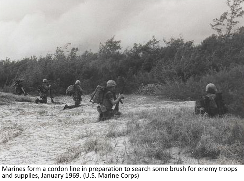 Marines form a cordon line in preparation to search some brush for enemy troops and supplies, January 1969. (U.S. Marine Corps)